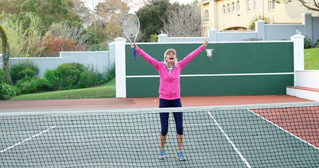 Excited woman celebrating victory on tennis court - Free Images, Stock Photos and Pictures on Pikwizard.com