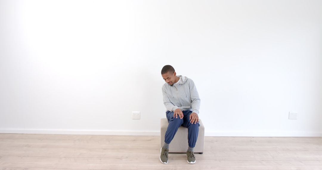 Casual Apparel Styled with Hoodie and Sneakers in Minimalist Space