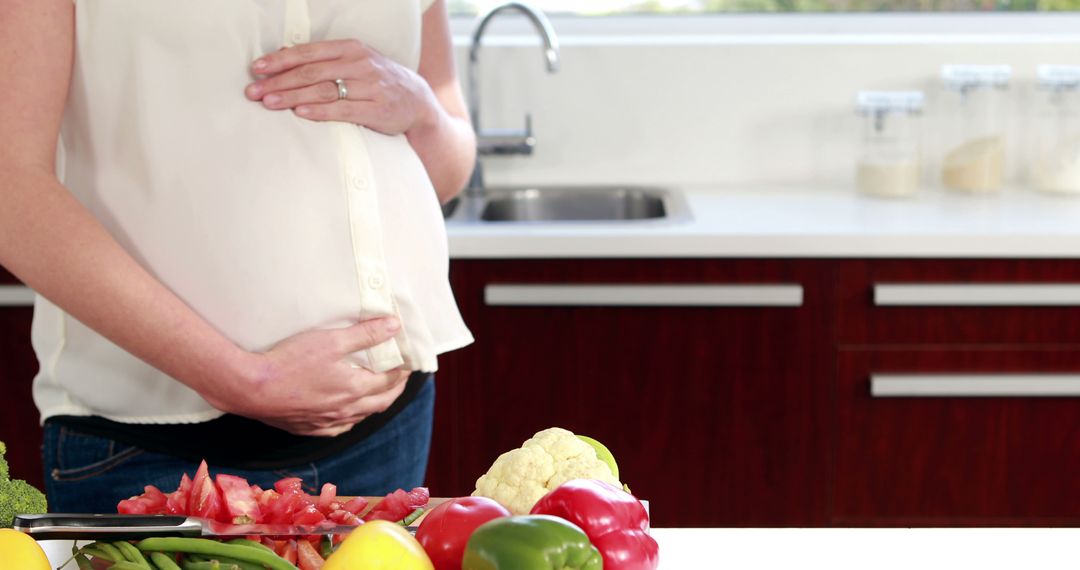 Pregnant Woman Preparing Healthy Meals in Modern Kitchen - Free Images, Stock Photos and Pictures on Pikwizard.com