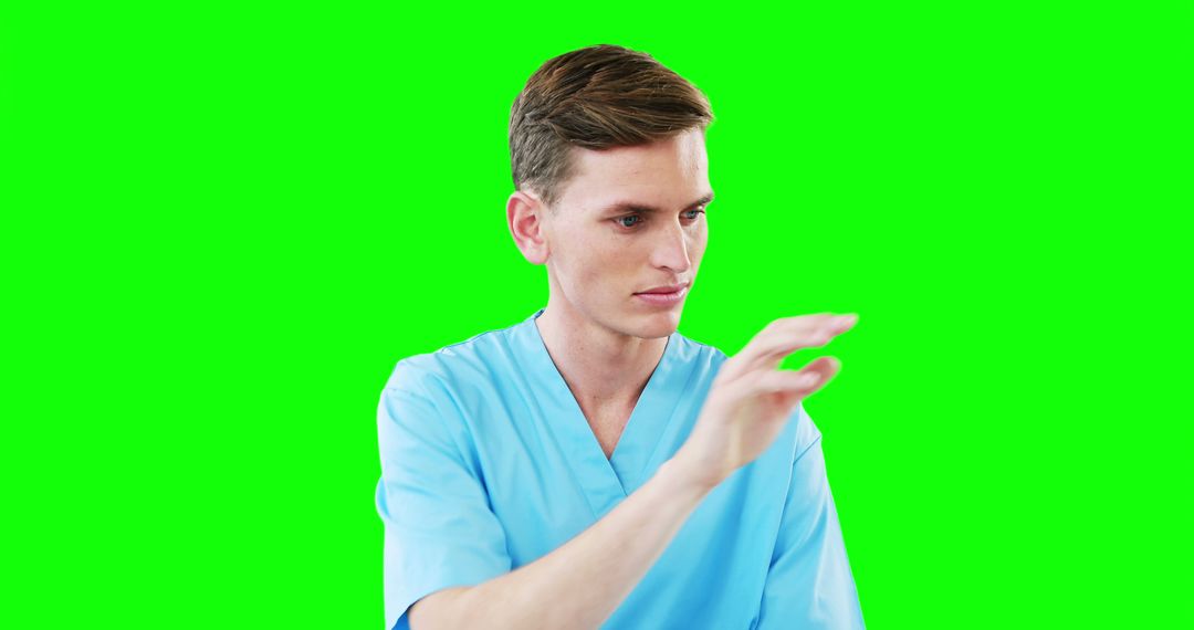 Male Nurse Interacting with Virtual Screen on Green Background - Free Images, Stock Photos and Pictures on Pikwizard.com