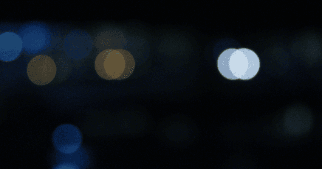 Defocused Illuminated Bokeh Lights on Transparent Dark Night Sky