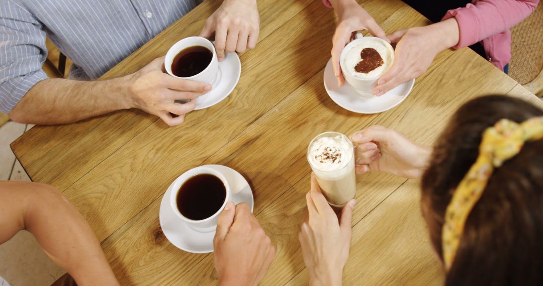 Friends Enjoying Coffee Together in a Cozy Café - Free Images, Stock Photos and Pictures on Pikwizard.com