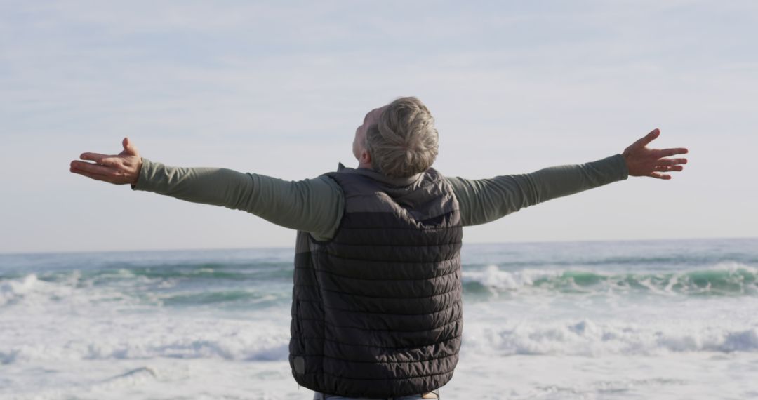 Elderly Man Embracing Ocean Breeze with Open Arms - Free Images, Stock Photos and Pictures on Pikwizard.com