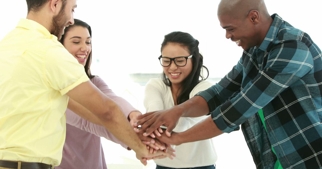 Diverse Team Huddling in Cheerful Office Environment - Free Images, Stock Photos and Pictures on Pikwizard.com