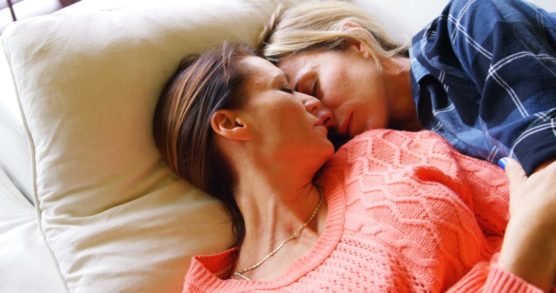 Couple Embracing Peacefully on Couch in Natural Light
