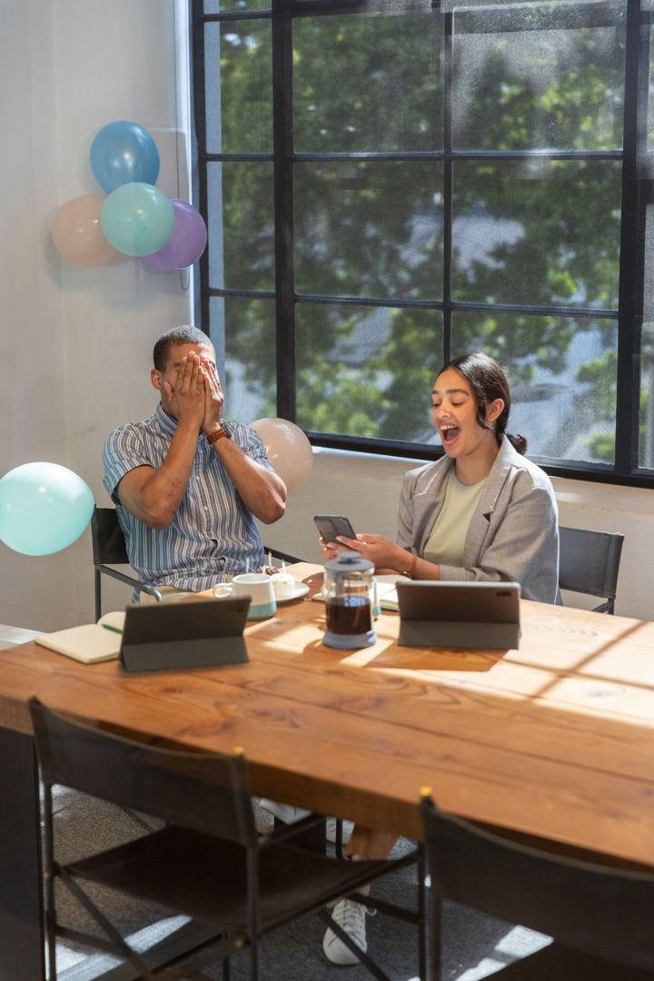 Colleagues Celebrating Office Milestone with Laughter and Balloons
