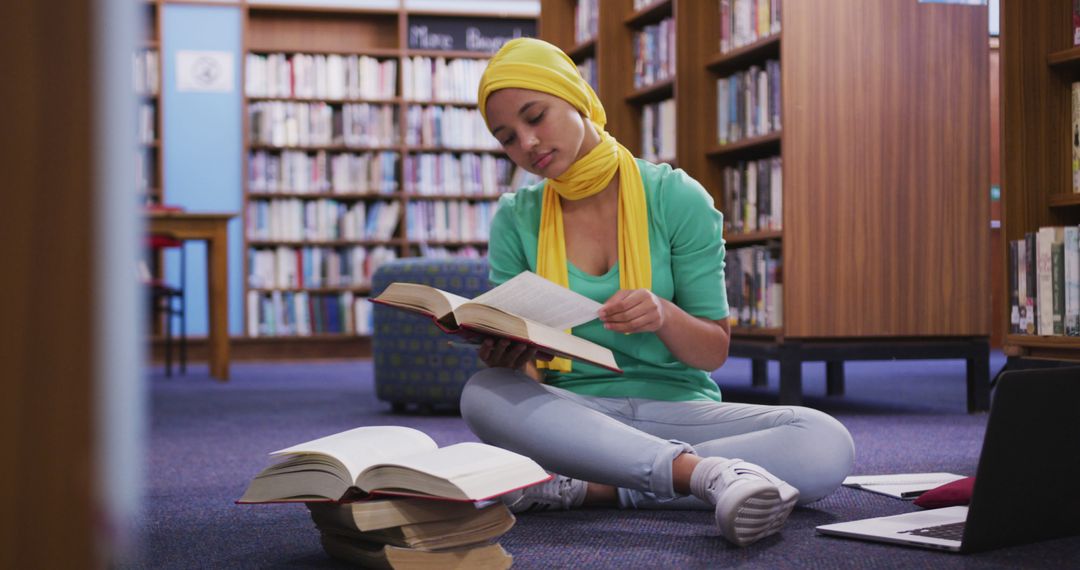 Young Woman Studying in Library with Books and Laptop - Free Images, Stock Photos and Pictures on Pikwizard.com