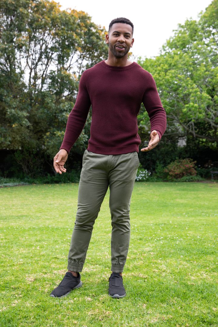 Casual Young Man Enjoying Time in Outdoor Garden Setting