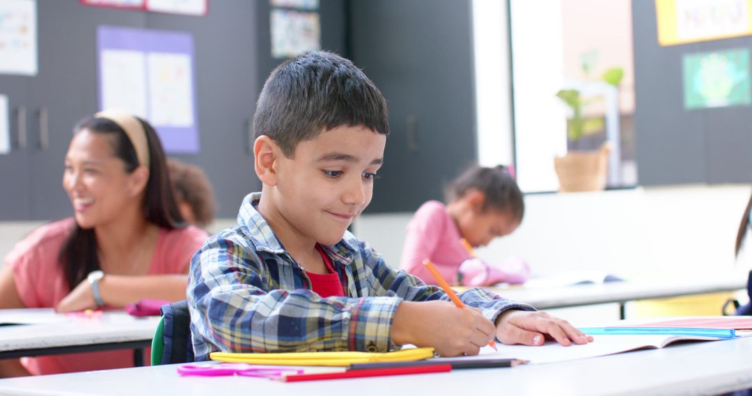 Boy Writing Focused on Classroom Activity