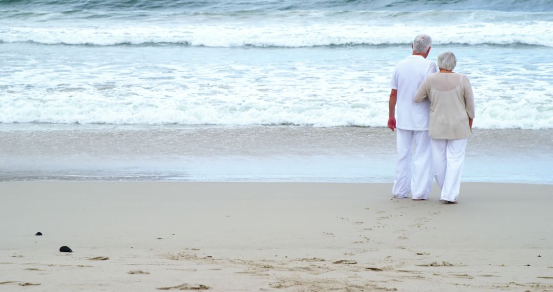 Senior Couple Strolling On Beach Shore - Free Images, Stock Photos and Pictures on Pikwizard.com