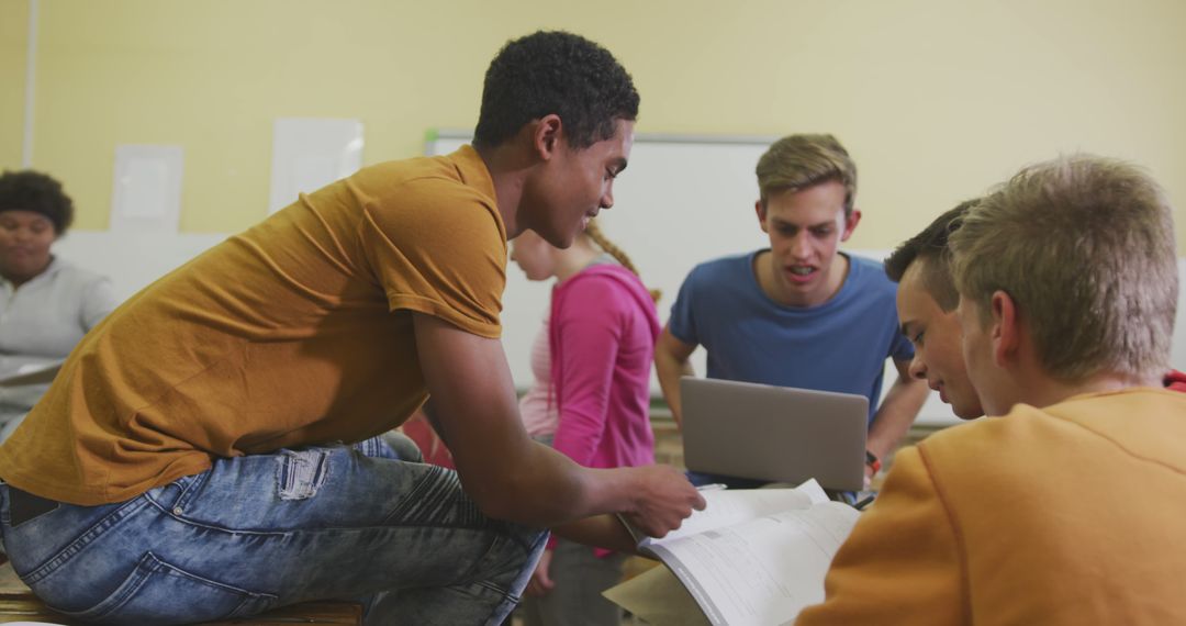 Diverse Students Collaborating with Laptop in Classroom