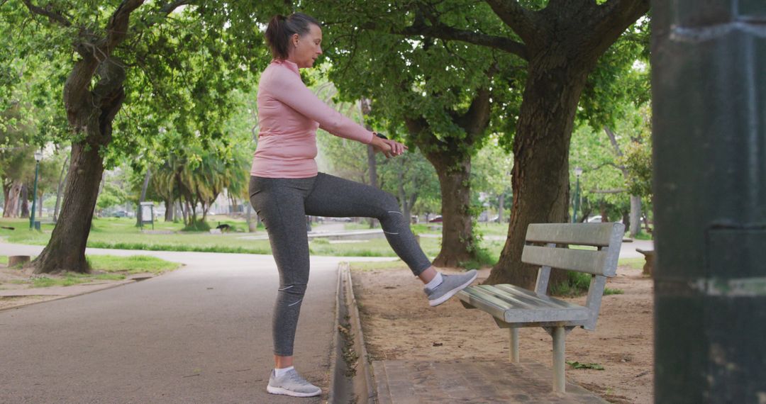 Woman Doing Leg Exercises on Park Bench in Casual Sportswear - Free Images, Stock Photos and Pictures on Pikwizard.com