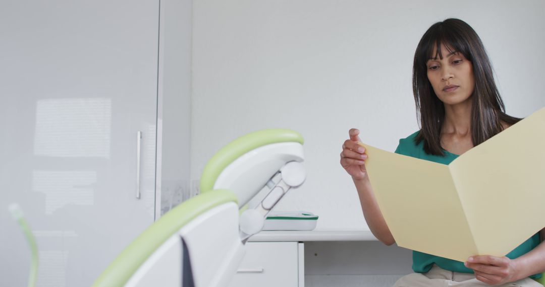 Female Dentist Reviewing Patient File in Modern Clinic - Free Images, Stock Photos and Pictures on Pikwizard.com