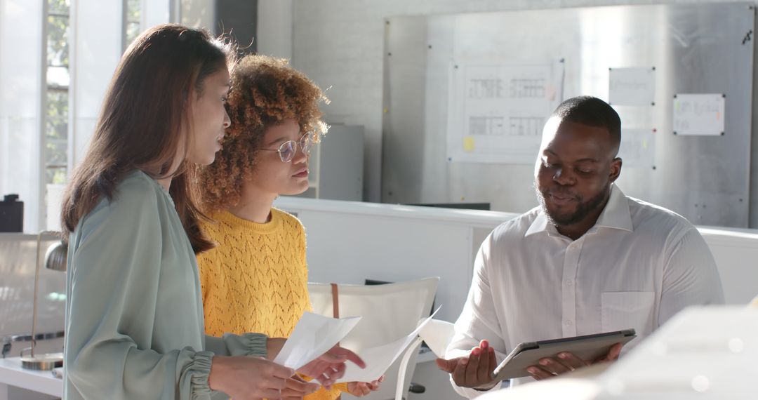 Diverse Team Collaborating with Digital Tablet in Office Meeting