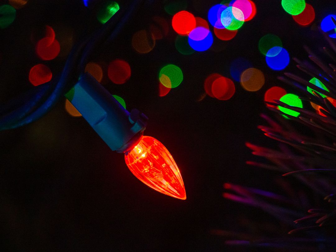 Glowing Red Holiday Light Amid Multicolored Bokeh