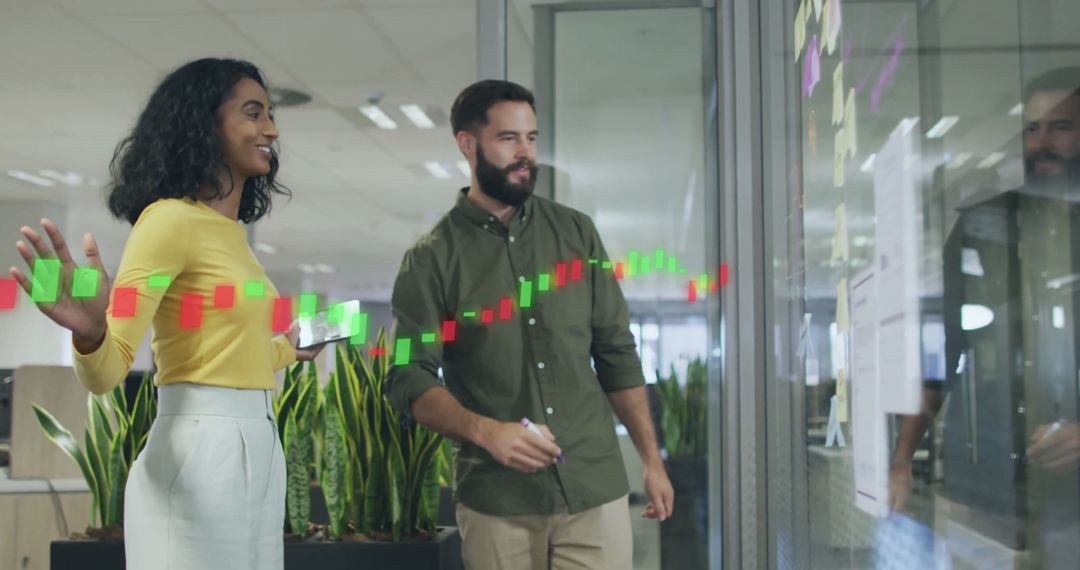 Diverse Colleagues Discuss Strategy with Diagrams on Glass Wall
