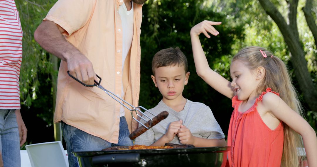 Family Enjoying Barbecue Outdoors in Backyard - Free Images, Stock Photos and Pictures on Pikwizard.com