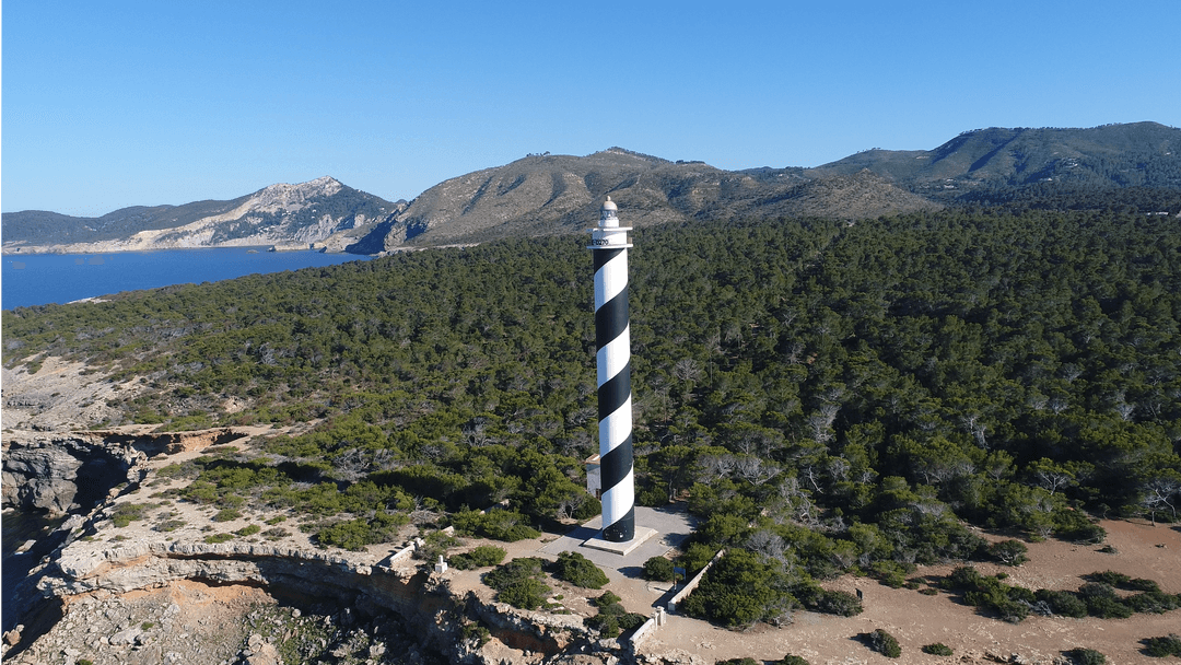 Elevated View of Striped Coastal Lighthouse Against Clear Sky