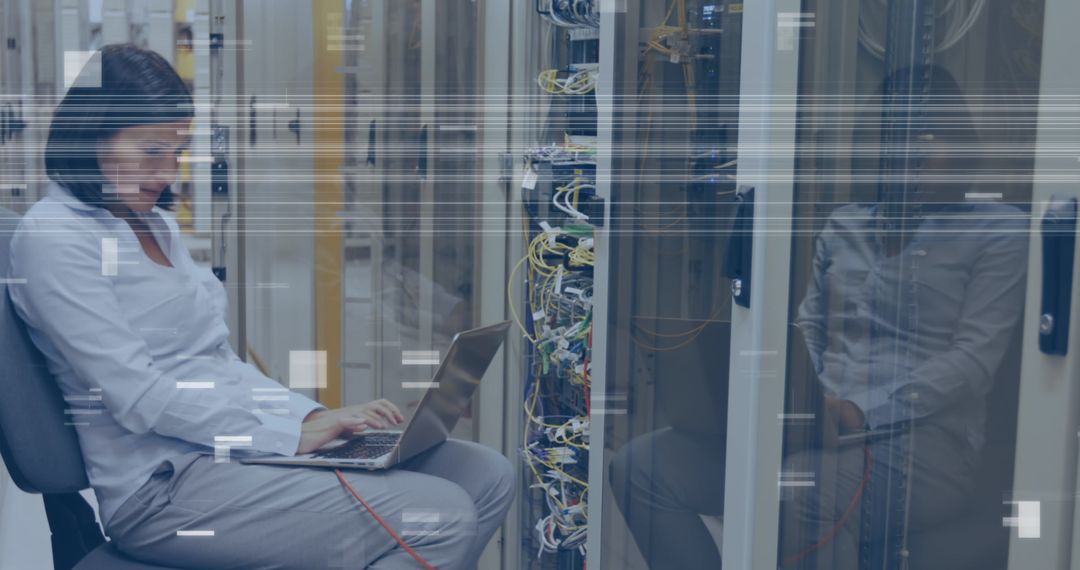 Middle Aged Woman Working on Laptop in Data Center Server Room