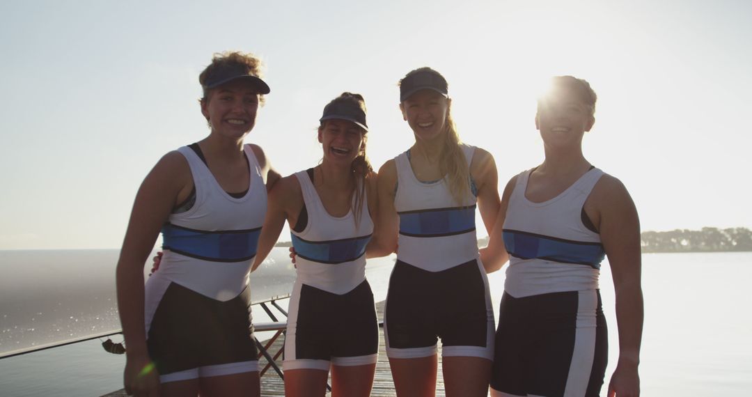 Four female rowers standing together smiling on a sunny day - Free Images, Stock Photos and Pictures on Pikwizard.com