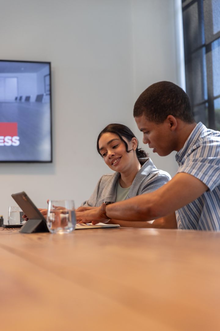 Diverse Coworkers Discussing Documents in Modern Office Space