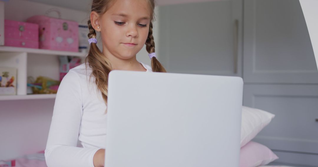 Young Girl Using Laptop in Bedroom with Pink Decor - Free Images, Stock Photos and Pictures on Pikwizard.com