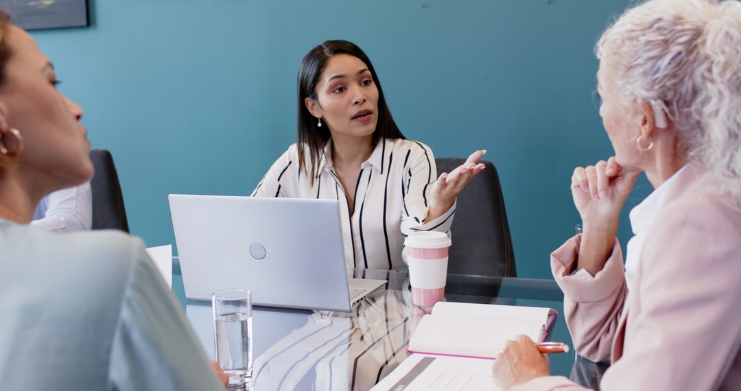 Business Meeting with Multiracial Team Collaborating Over Laptop