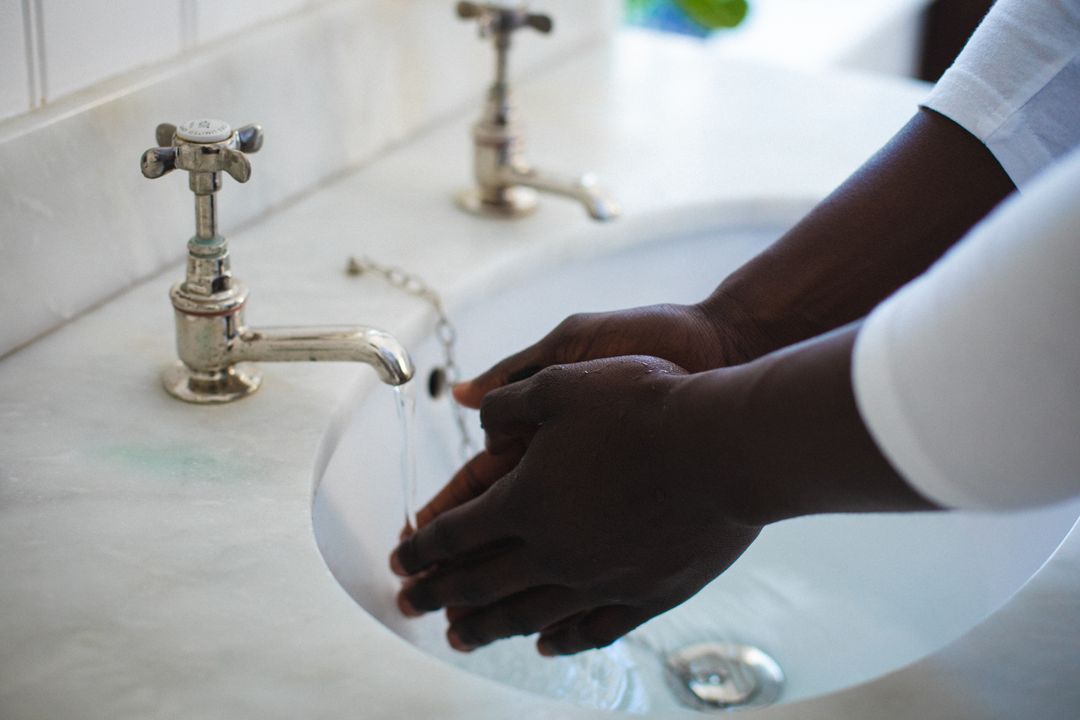 Cropped image of african american young man washing hands in bathroom sink, copy space - Free Images, Stock Photos and Pictures on Pikwizard.com