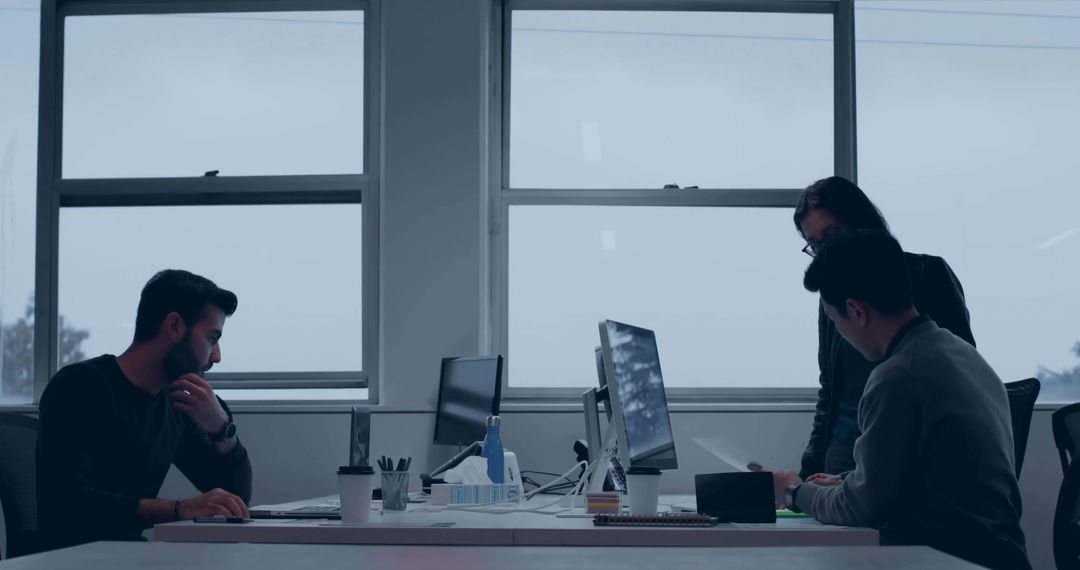 Modern Office Team Collaborating Around Desktop