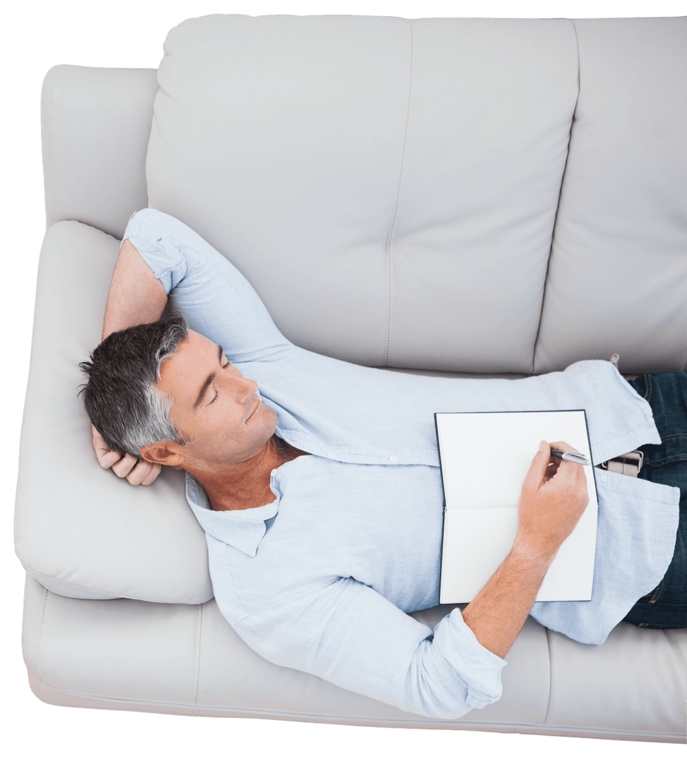 Mature Man Relaxing on Sofa with Notebook and Pen