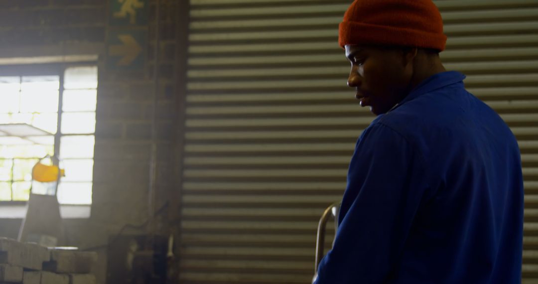 Industrial Worker Using Blow Torch in Metal Workshop