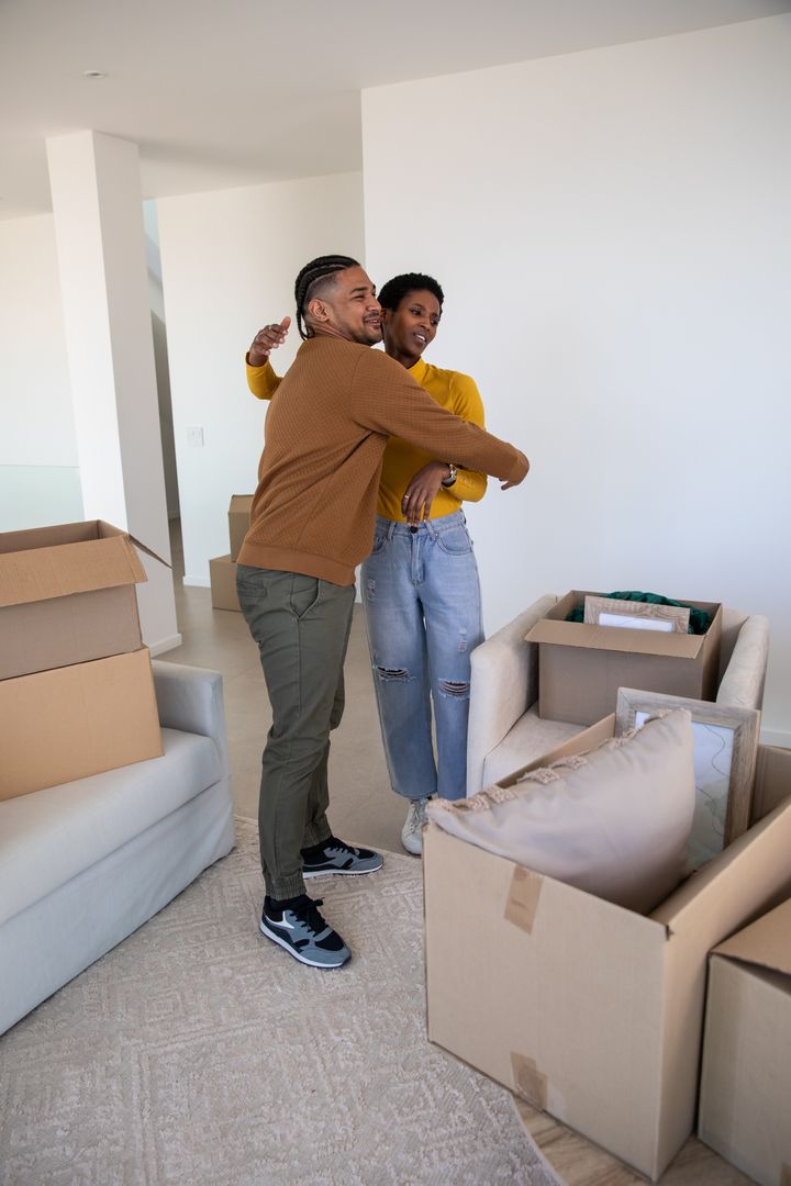 Happy Couple Embracing During Move in Modern Home