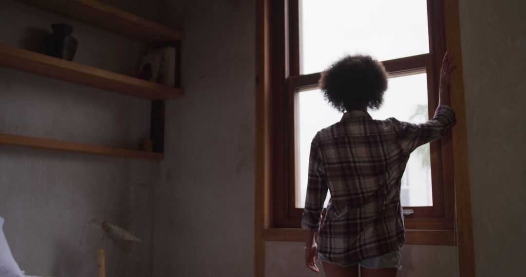 Person Looking Out of Window in Cozy Room - Free Images, Stock Photos and Pictures on Pikwizard.com