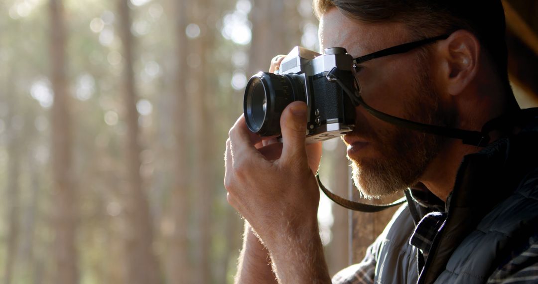 Man Enthusiastically Taking Photographs with Camera in Nature