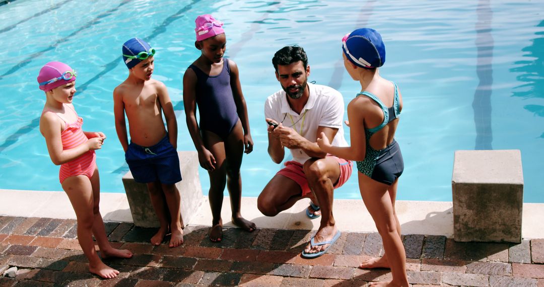 Swimming Coach Instructing Group of Children by Poolside - Free Images, Stock Photos and Pictures on Pikwizard.com