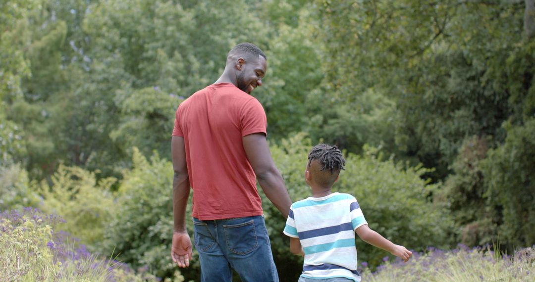 Father and Son Strolling Together in Lush Green Park Battleground