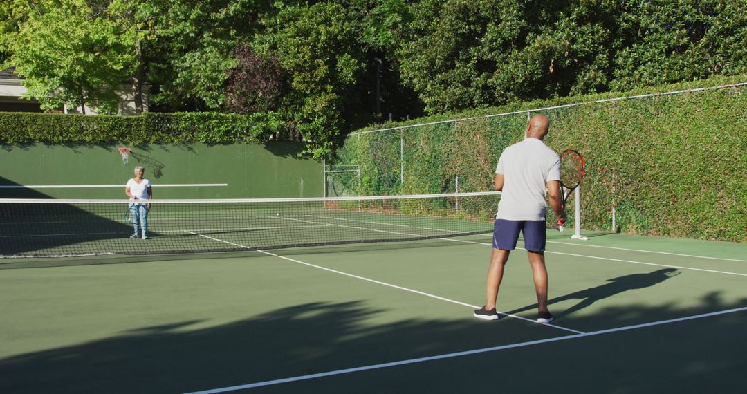 Two Friends Playing Tennis on Outdoor Court on Sunny Day - Free Images, Stock Photos and Pictures on Pikwizard.com