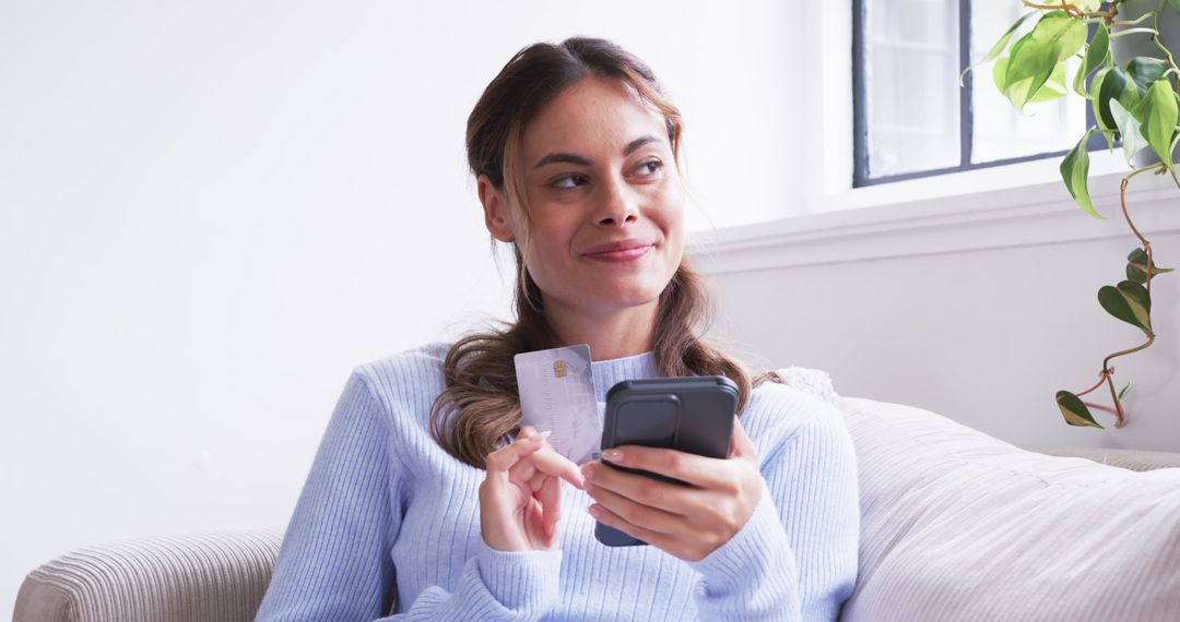 Woman Shopping Online with Smartphone on Comfortable Couch