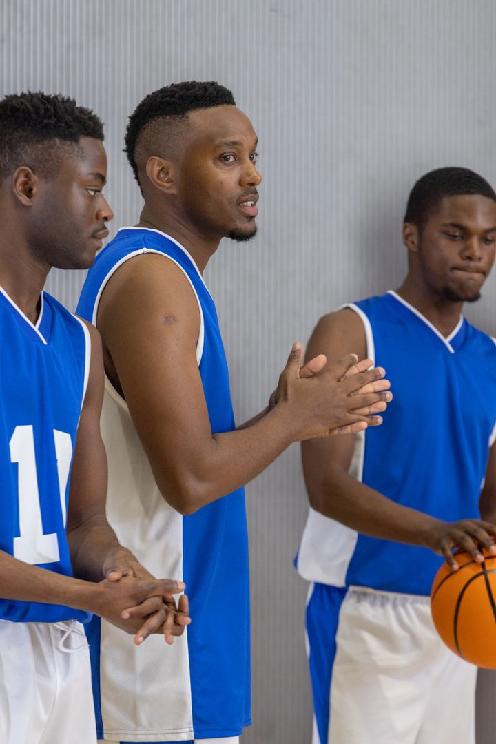 Basketball Team Strategizing at Courtside