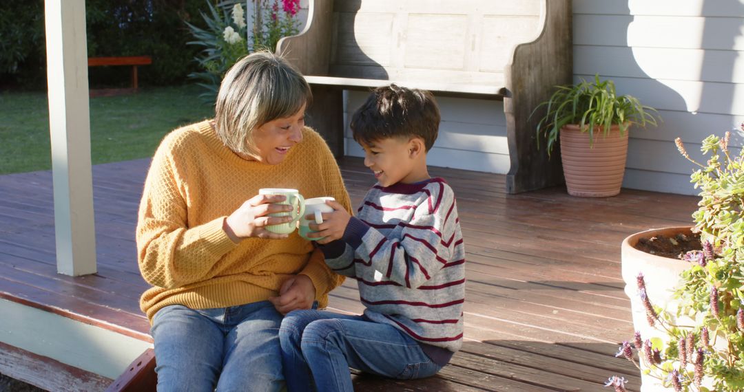 Grandmother and Boy Drinking Hot Drinks on Porch - Free Images, Stock Photos and Pictures on Pikwizard.com