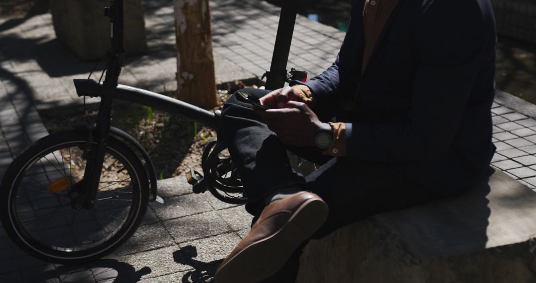 Businessman Resting with Foldable Bicycle in Urban Area - Free Images, Stock Photos and Pictures on Pikwizard.com