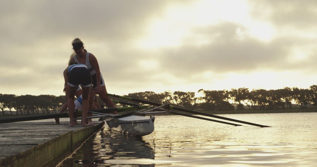 Rowers Preparing to Launch Boat at Sunrise on Lake - Free Images, Stock Photos and Pictures on Pikwizard.com