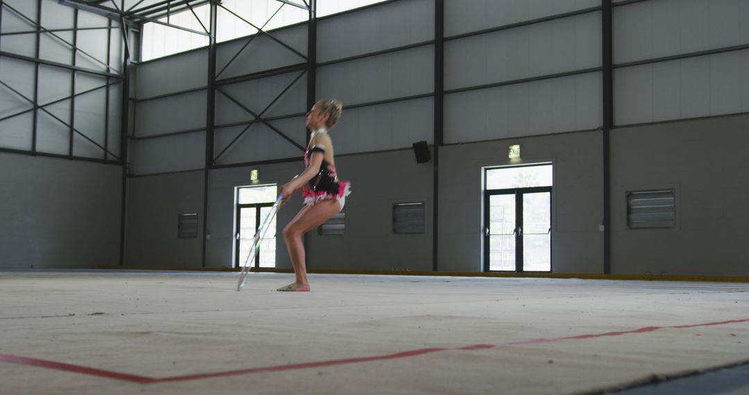 Young Gymnast Performing Rhythmic Routine in Gymnasium - Free Images, Stock Photos and Pictures on Pikwizard.com