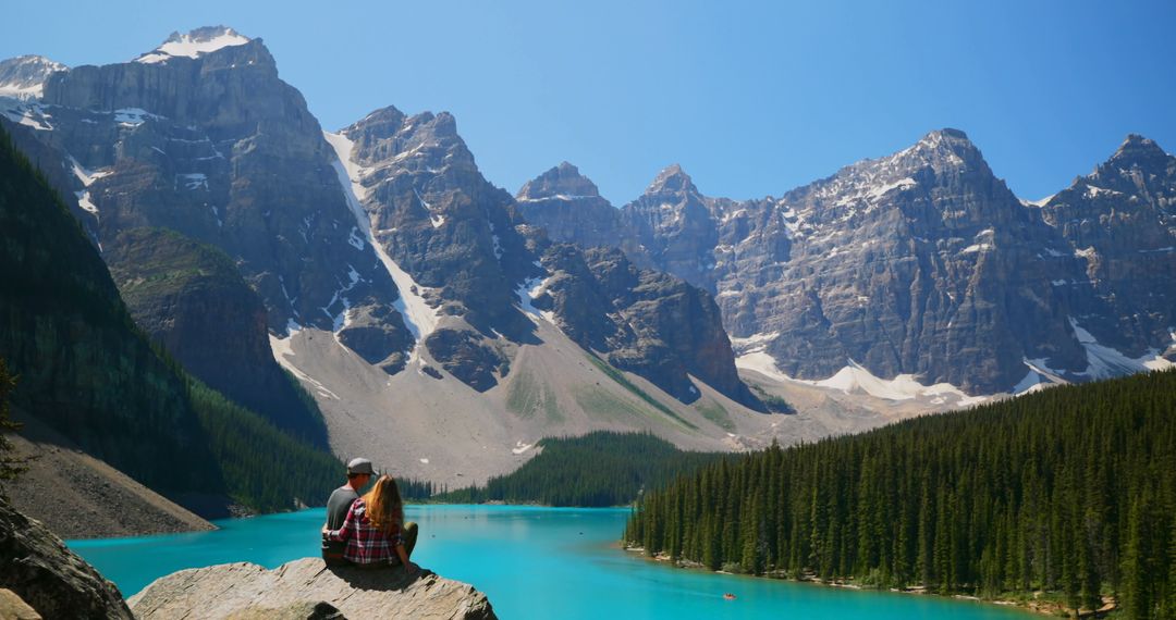 Couple Admiring Mountain Scenery Over Pristine Lake - Free Images, Stock Photos and Pictures on Pikwizard.com