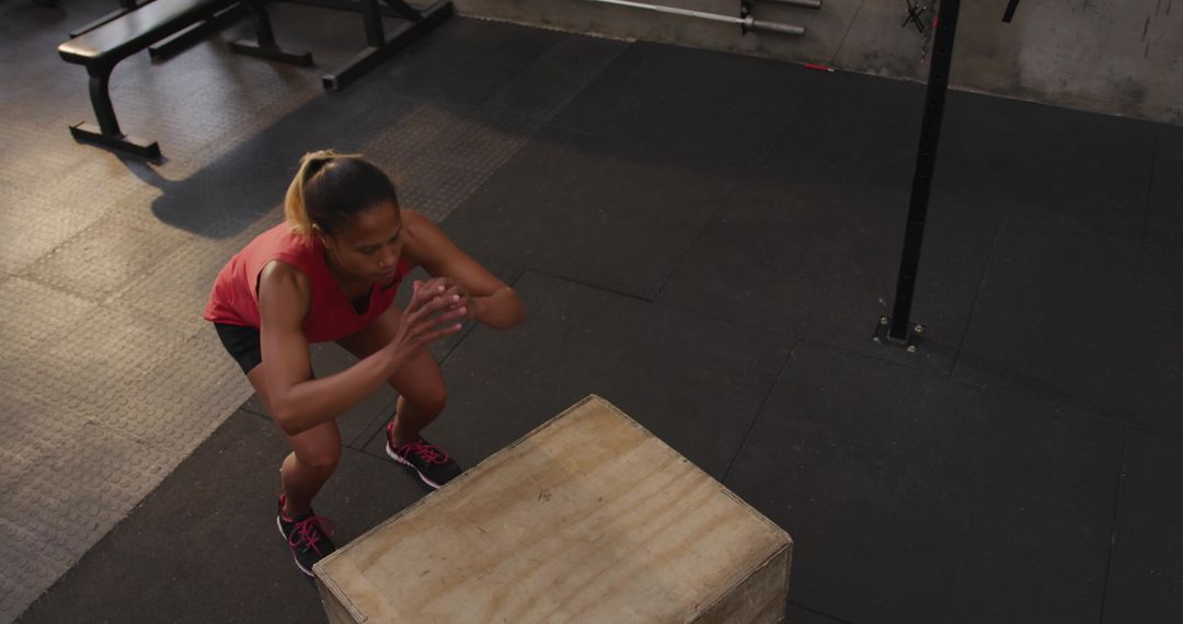 Female Athlete Performing Box Jump at Fitness Gym