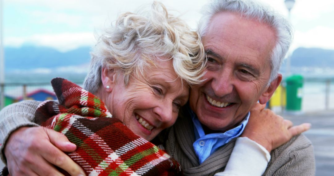 Happy Senior Couple Embracing Outdoors on Cold Day - Free Images, Stock Photos and Pictures on Pikwizard.com