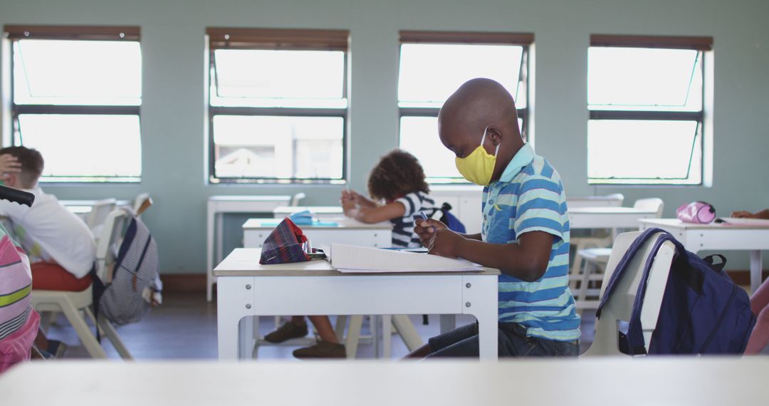 Young Student Studying in Classroom with Mask During Pandemic - Free Images, Stock Photos and Pictures on Pikwizard.com