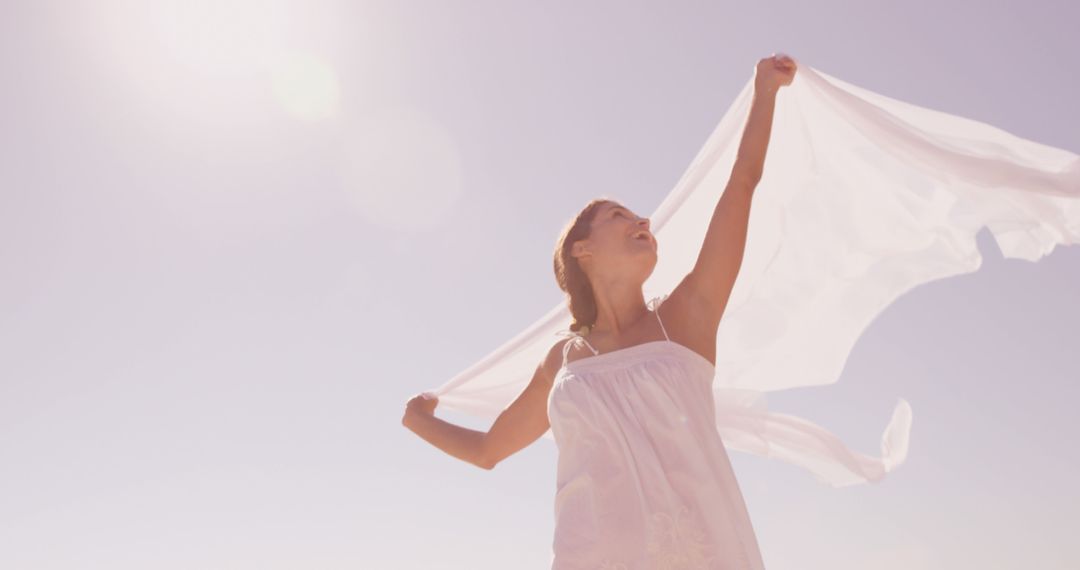 Young Girl Holding Fabric with Joy on a Sunny Day - Free Images, Stock Photos and Pictures on Pikwizard.com