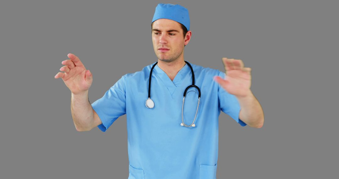 Confident Doctor Gesturing with Both Hands in Blue Scrubs - Free Images, Stock Photos and Pictures on Pikwizard.com