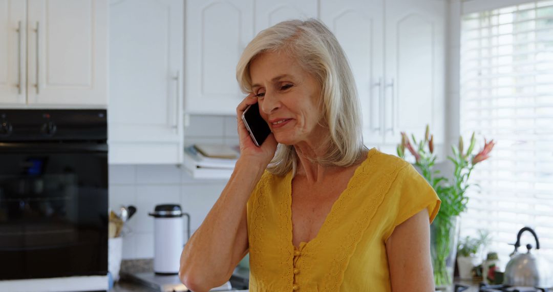 Senior Woman Having Phone Call in Bright Kitchen - Free Images, Stock Photos and Pictures on Pikwizard.com